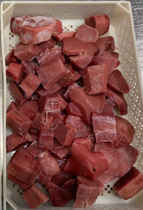 Bits and pieces of raw tuna loin - frozen